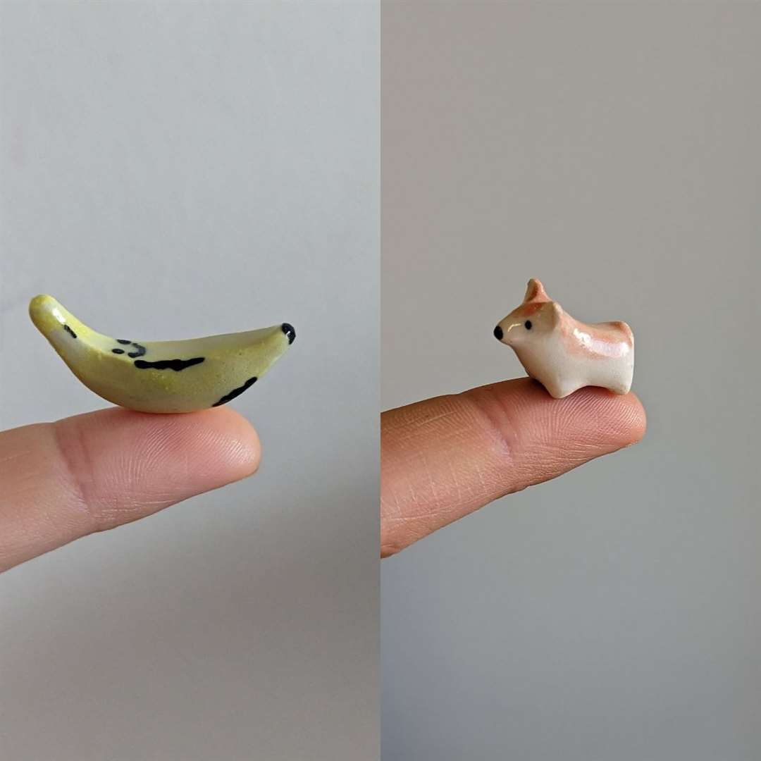 A miniature ceramic banana next to a miniature ceramic corgi (Veronika McQuade/PA)