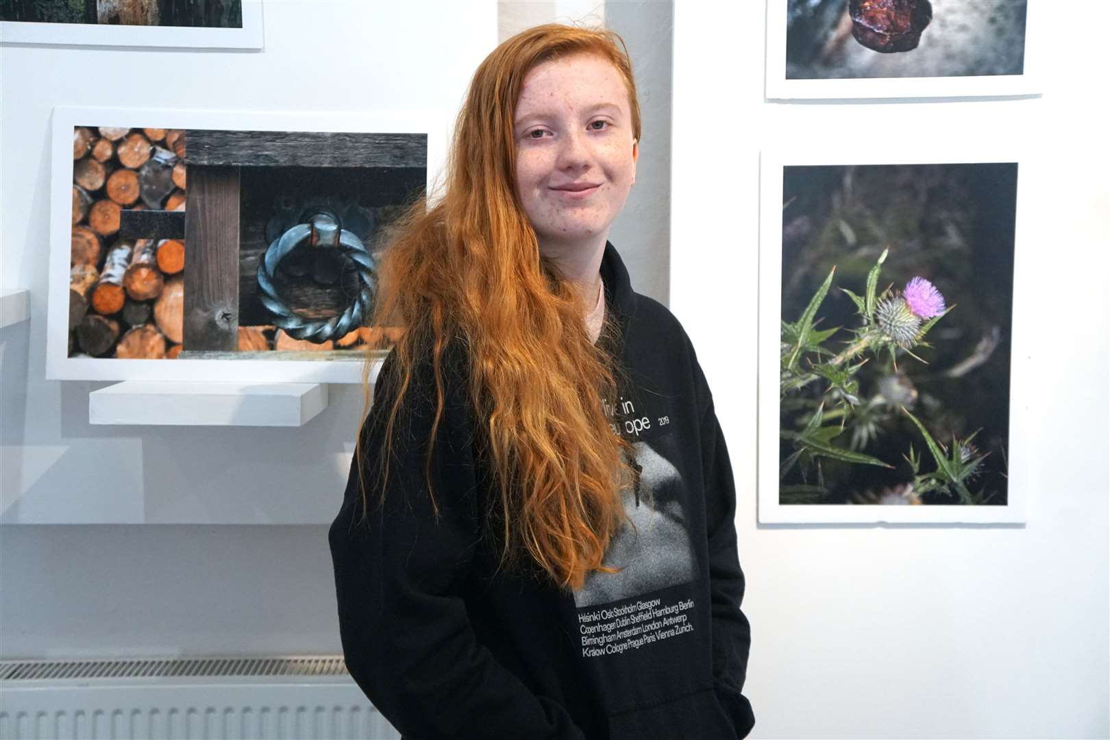 Eilidh McPhee stands beside two of her images on show at the Quatre Bras gallery in Lybster.