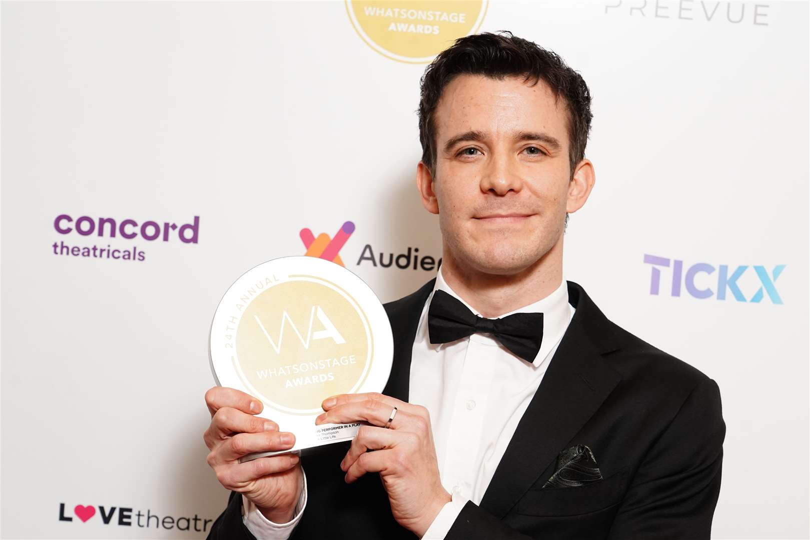 Luke Thompson with his award for best supporting performer in a play (Ian West/PA)