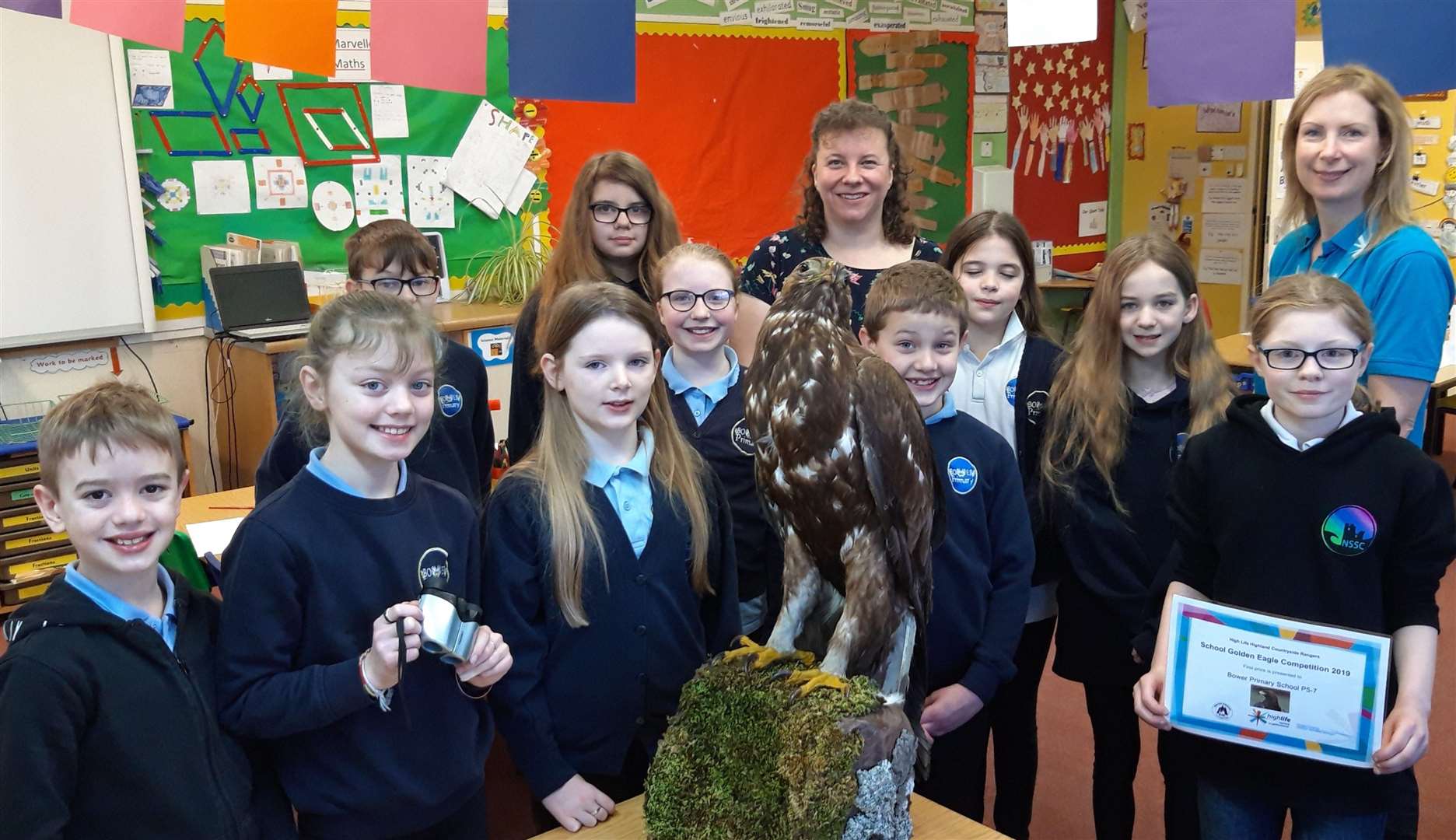 Bower pupils are presented with their certificate and binoculars by local High Life Highland countryside ranger Marina Swanson (far right). Also in the picture is teacher Claire Henderson.