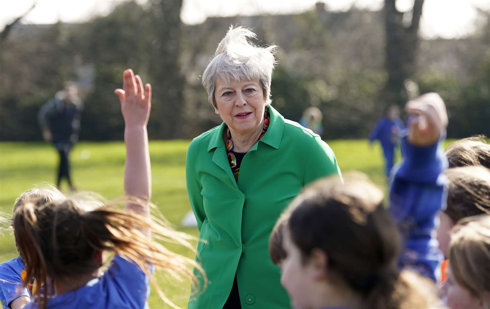 Theresa May talks to schoolgirls at a football session during a visit to St Mary’s Catholic Primary School in Maidenhead, Berkshire (Andrew Matthews/PA)