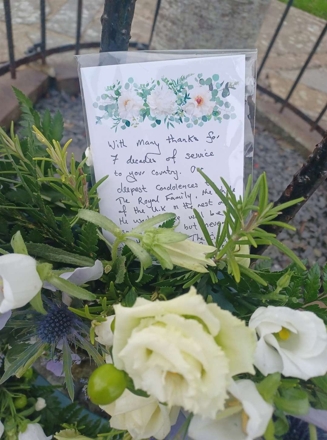 The message on the wreath at Wick acknowledging Her Majesty's 70 years of service and expressing condolences to the royal family.