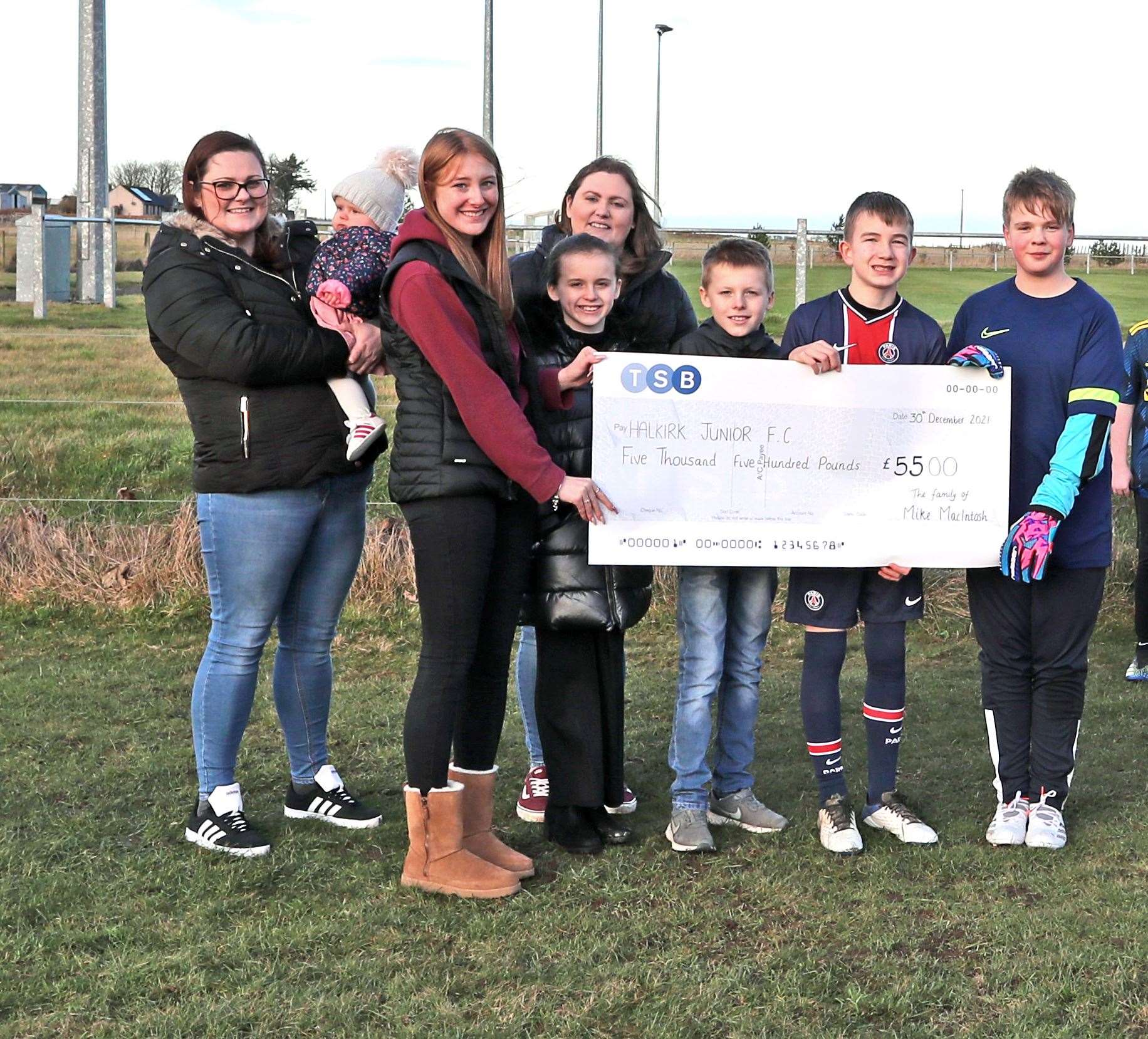 From left: Eilidh Munro, Isla Sutherland, Erin Macintosh, Lynsey Munro, Charley Noble, Zac Noble, Shay Coghill and Mackenzie Westwood with the cheque for Halkirk Junior FC. Picture: James Gunn