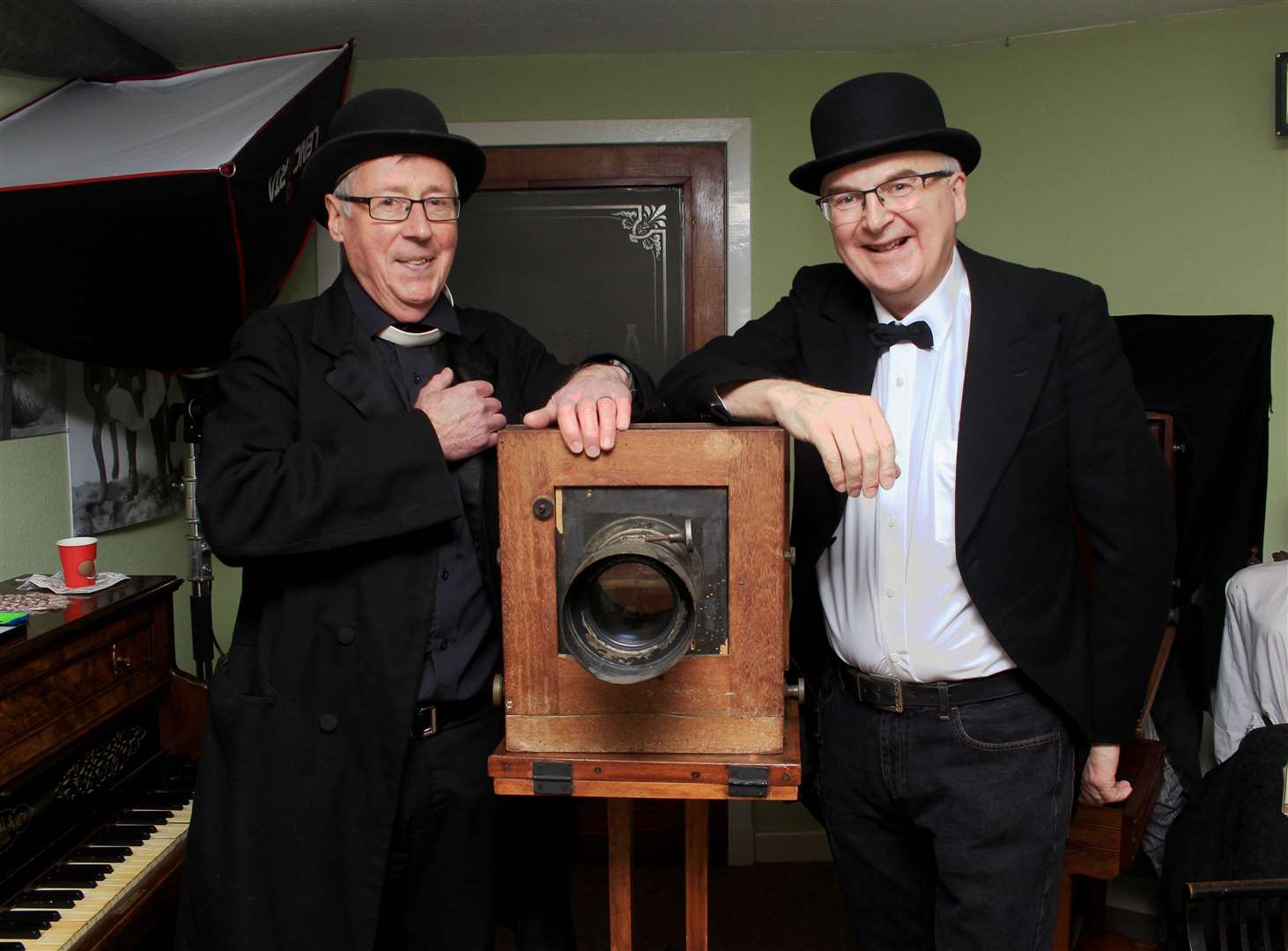 Fergus Mather (left) of the Wick Society's Johnston photographic section in the Johnston studio preparing to take an old-style portrait of visitor James Gunn. Picture: Alan Hendry