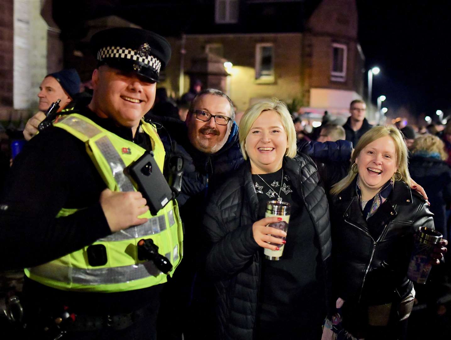 Party-goers with a friendly policeman in Thurso at New Year 2020. Picture: John Wright Studio