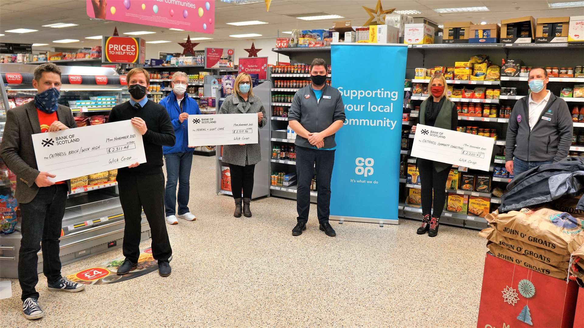 Inside Wick's Co-op store are from left, Chris Aitken (Caithness Broch Project/Wick High School), Craig Ross (Caithness Broch Project/Wick High School), Roy Mackenzie (Hearing and Sight Care, Caithness and North Sutherland), Deirdre Aitken (Hearing and Sight Care, Caithness and North Sutherland), Modris Karklins (store manager, Wick), Claire Clark (Caithness Community Connections) and Jamie Robson (Co-op member pioneer, Wick). Picture: DGS