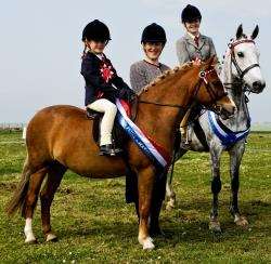 Erin Hewitson, ridden pony champion, and Maxwelltown Marenka (left) with reserve champion Katie Kennedy and Dorlyn Master of Arts.