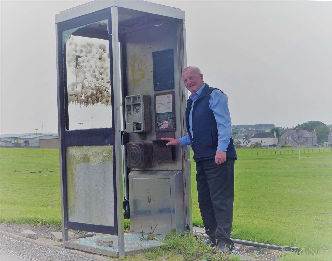 Councillor Willie Mackay beside the damaged phone box at Wick's Bignold Park.