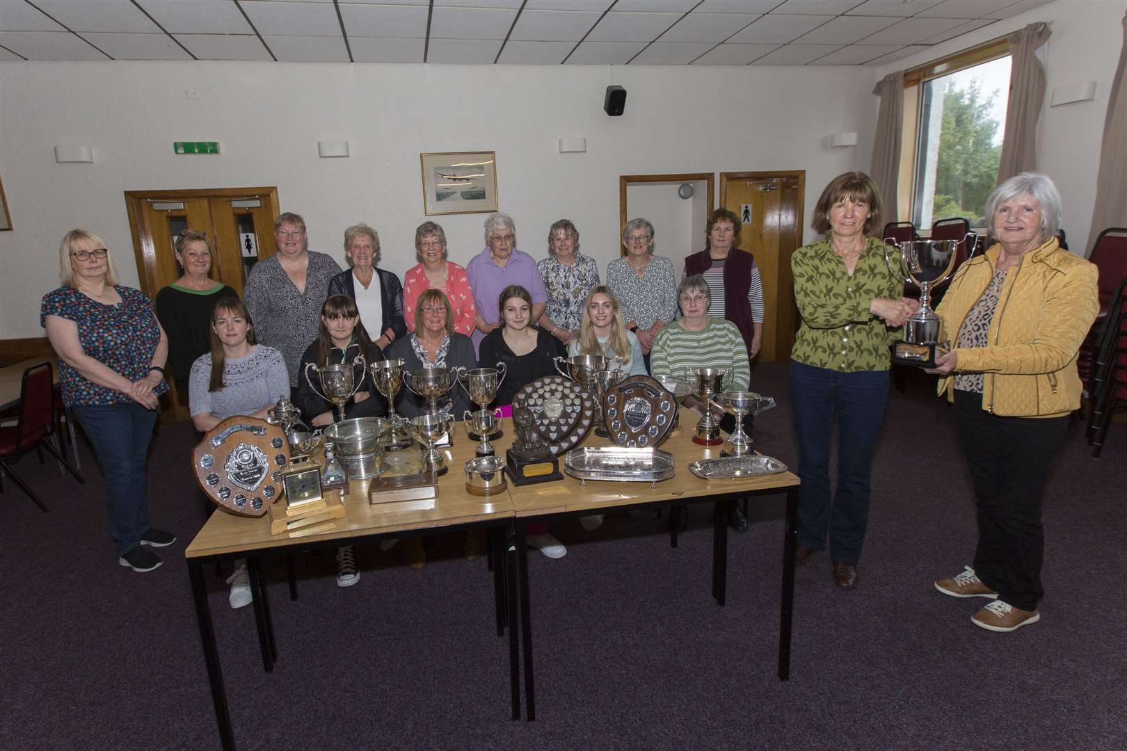 Carol Grant, of Latheron SWI accepts the trophy for the institute with most points, from Margaret Malcolm (right), of Buds and Blooms Florists, while looking on are some of the other trophy winners. Picture: Robert MacDonald/Northern Studios