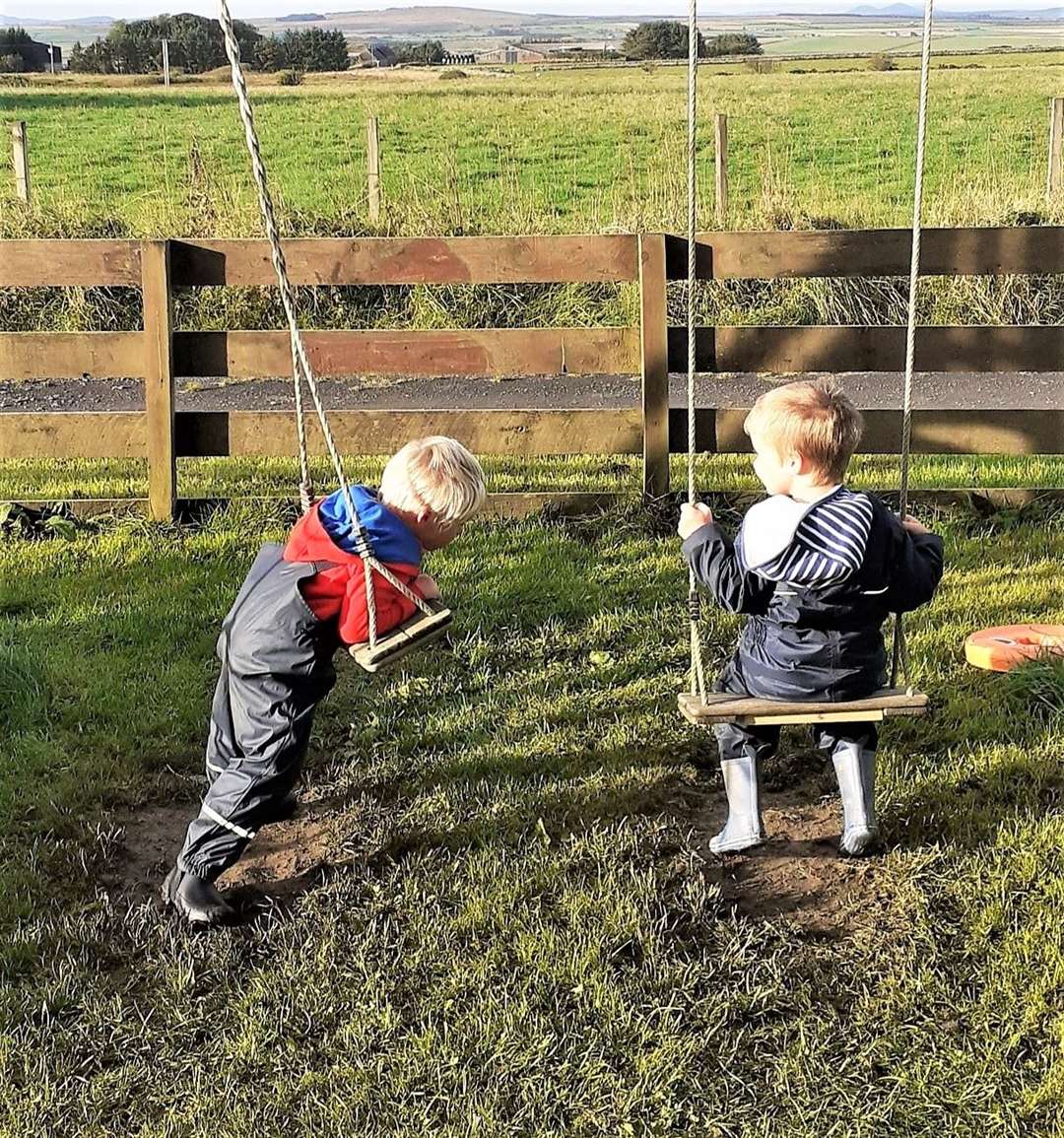 Finlay Silverwood, left, and Austen Foubister play on the swing at the Busy Bees nursery.