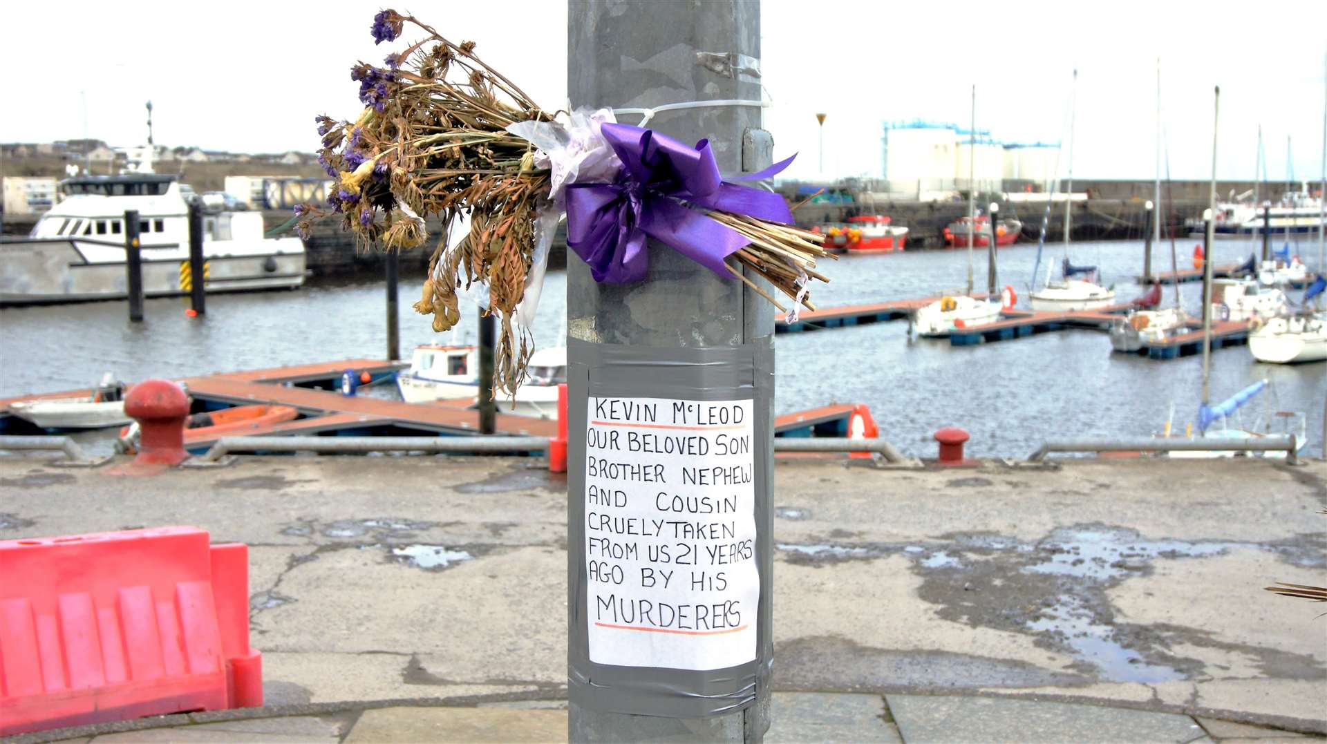 Flowers have been frequently left at Wick harbour near the site where Kevin died. Picture: DGS