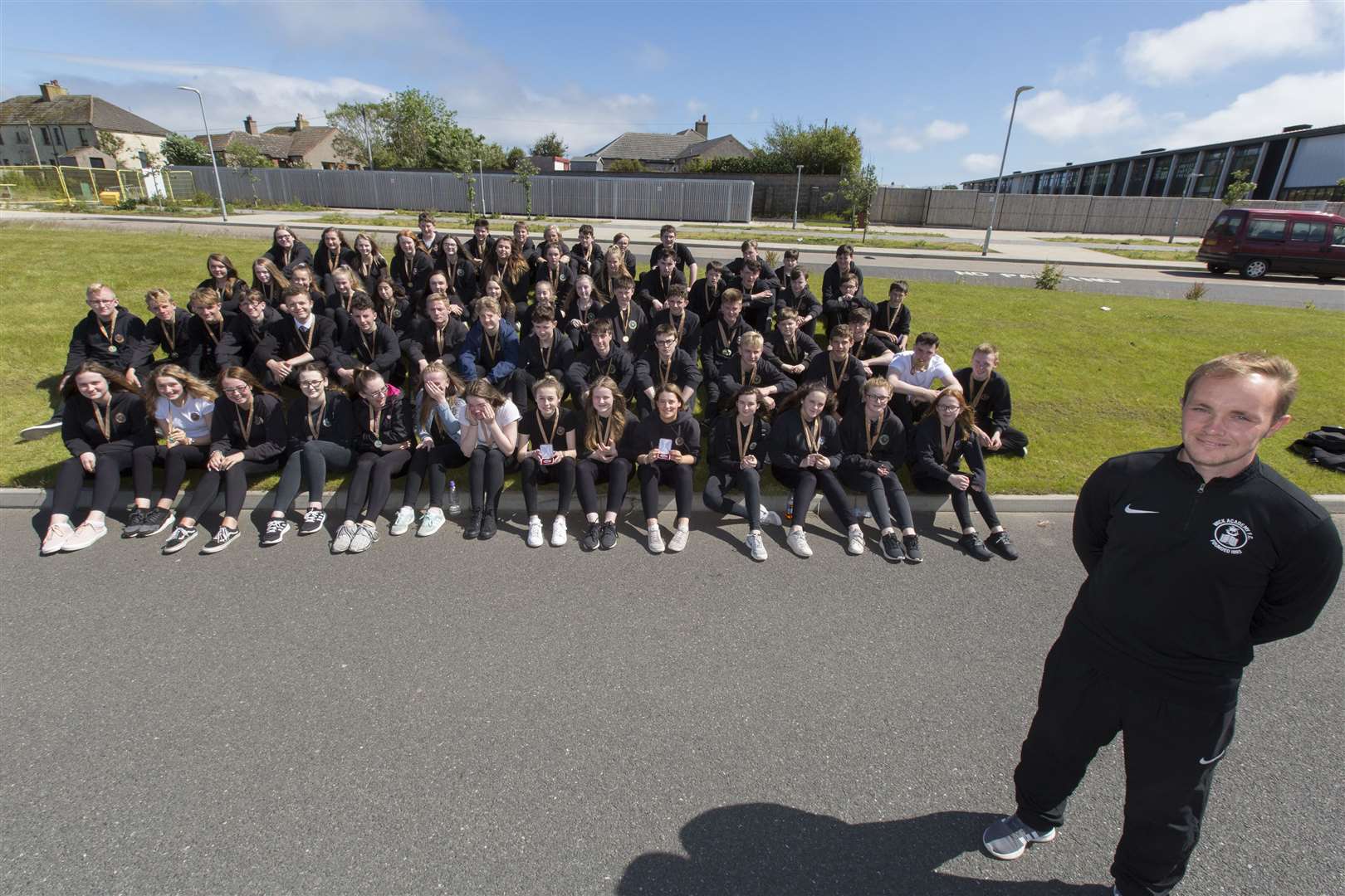 Wick High School sports medal winners pose for the camera before breaking up for the summer holidays. The awards were handed over by Wick Academy's Richard Macadie (foreground). Picture: Robert MacDonald / Northern Studios