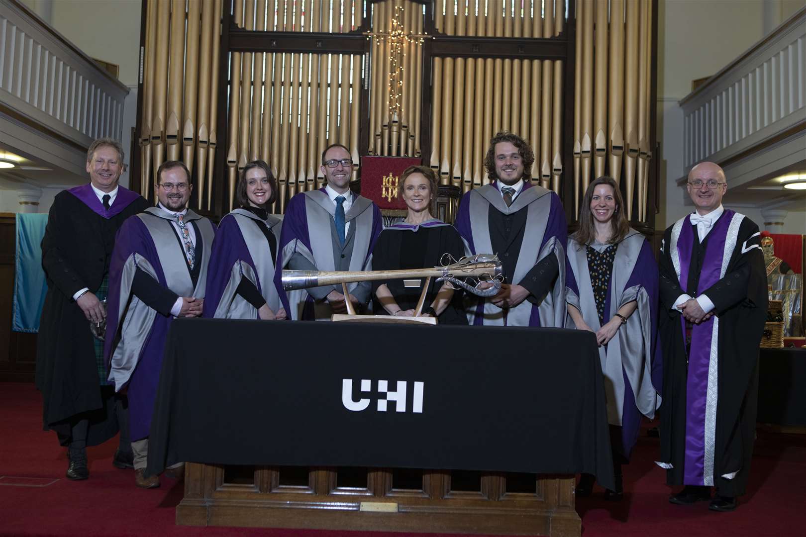 UHI North Highland principal Debbie Murray (centre) with Stuart Gibb (left), Neil Simco, UHI vice principal research and impact (right), and some of the PhD graduates.
