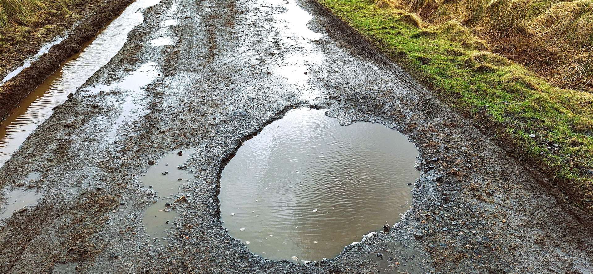 The road has broken down at one side and has a massive, deep pothole that is almost impossible to avoid driving into. Picture: DGS