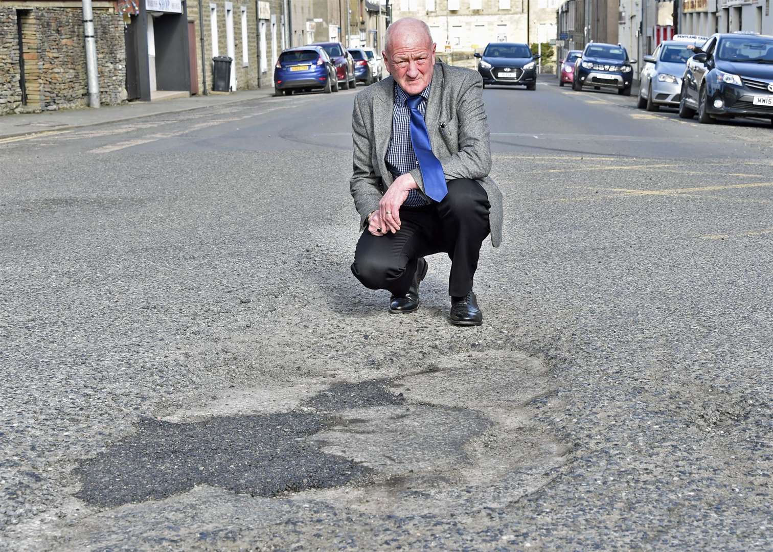 Iain Gregory in Princes Street, Thurso – this area of damaged roadway is on the driving line for vehicles turning right to go through the traffic lights. Picture: Mel Roger