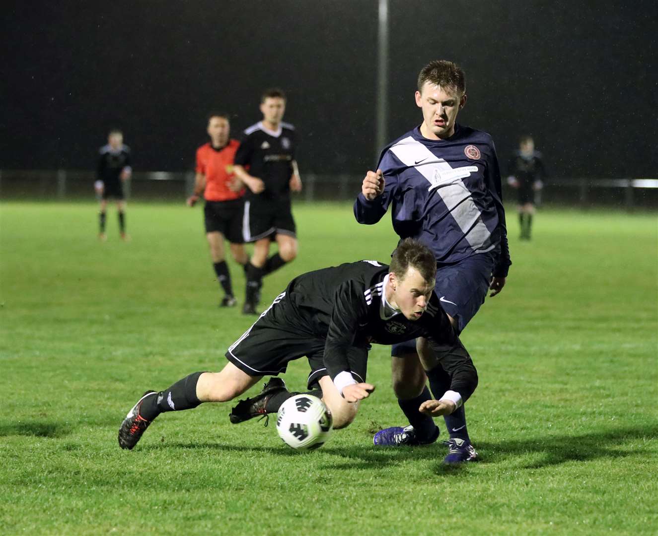 Allan Munro of Thurso takes a tumble in front of Halkirk United's Andy Mackay. Picture: James Gunn