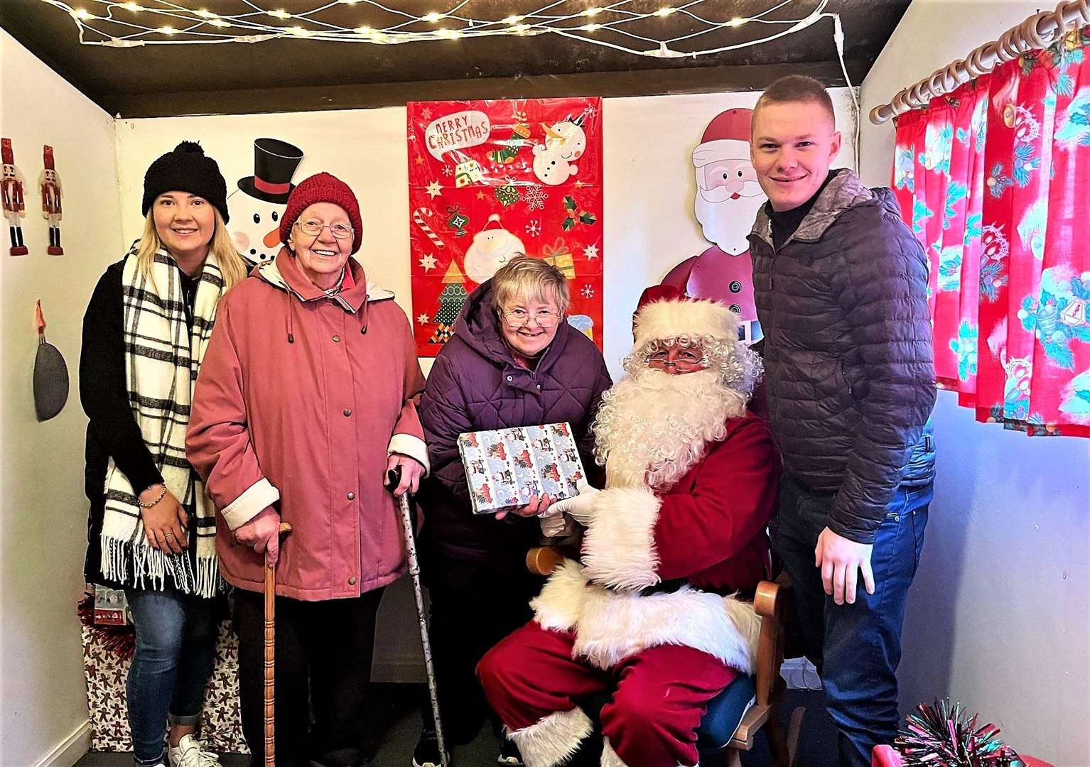 From left, Melissa Green, Lily and Lorraine MacGregor, Santa and Kyle MacGregor in the grotto.