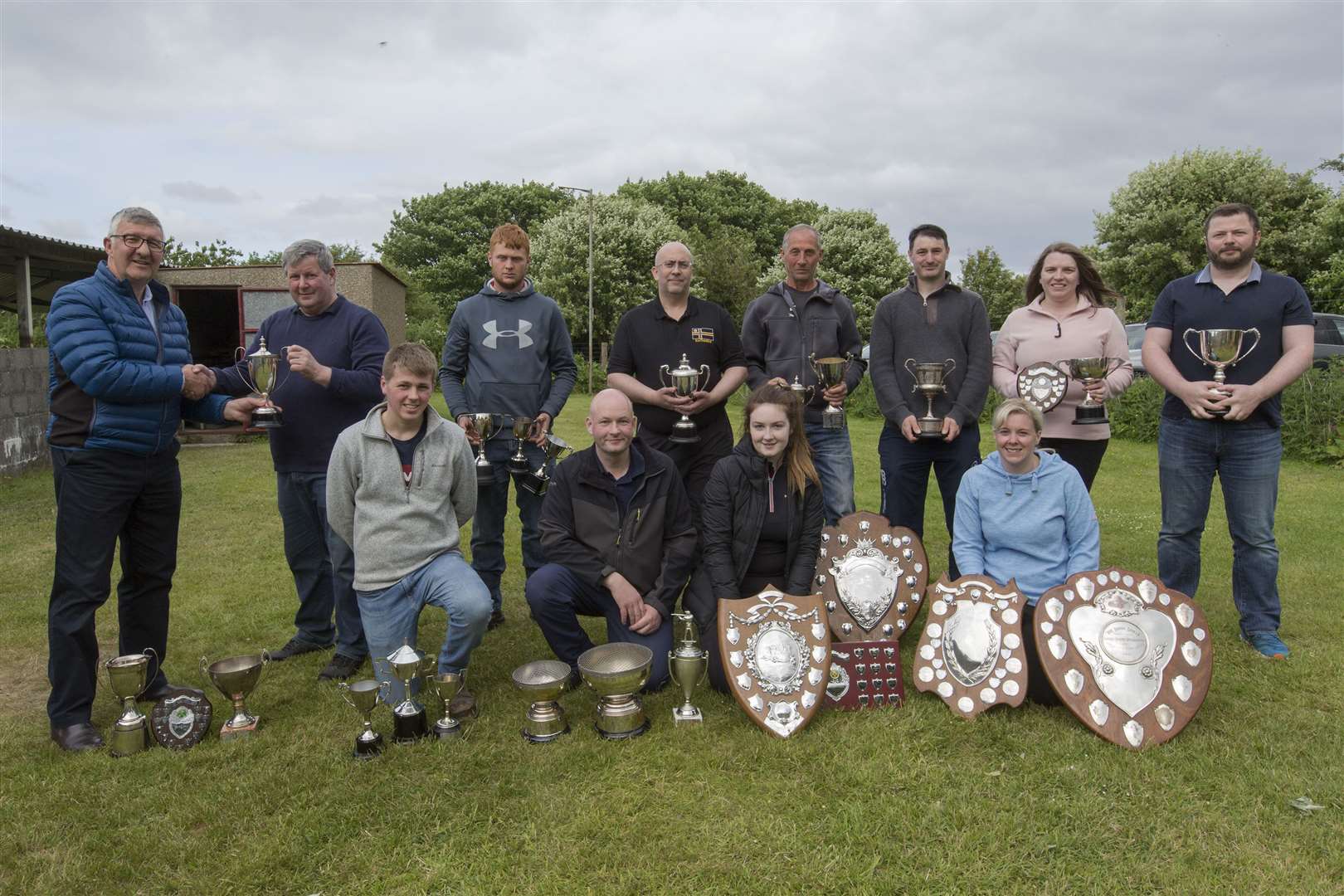 County champion Hugh Simpson, of Wick Old Stagers, receives one of his trophies from Vice-Lieutenant Willie Watt (left) at the end of Caithness Small Bore Rifle Association's annual open shoot. Looking on are some of the other trophy-winners who took part in the event in the outdoor range at Wick riverside. Picture: Robert MacDonald / Northern Studios