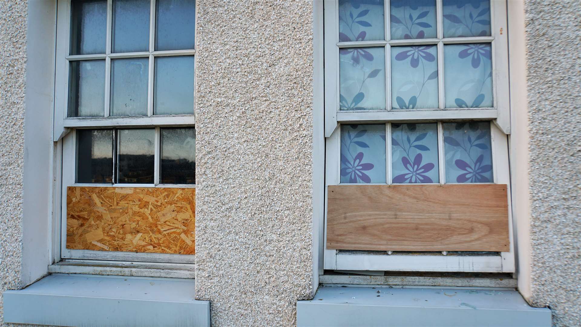 Windows to John Glover's flat have been smashed in and boarded up. Pictures: DGS