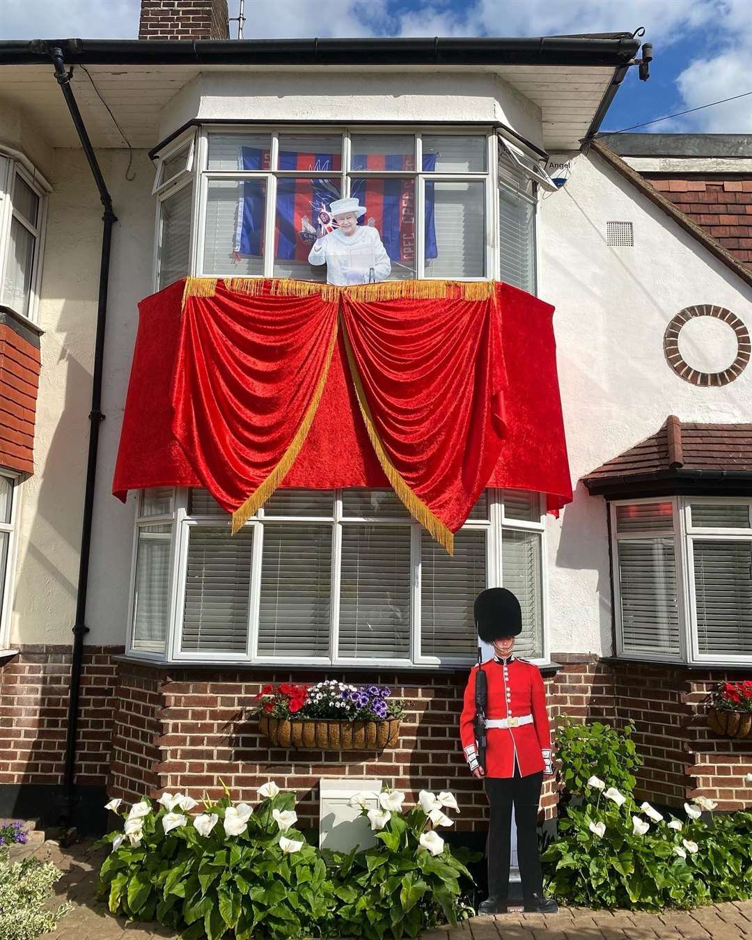 Decorations including a life-size cut-out of the Queen at a home in Bromley, south London (Athina Hapeshis)