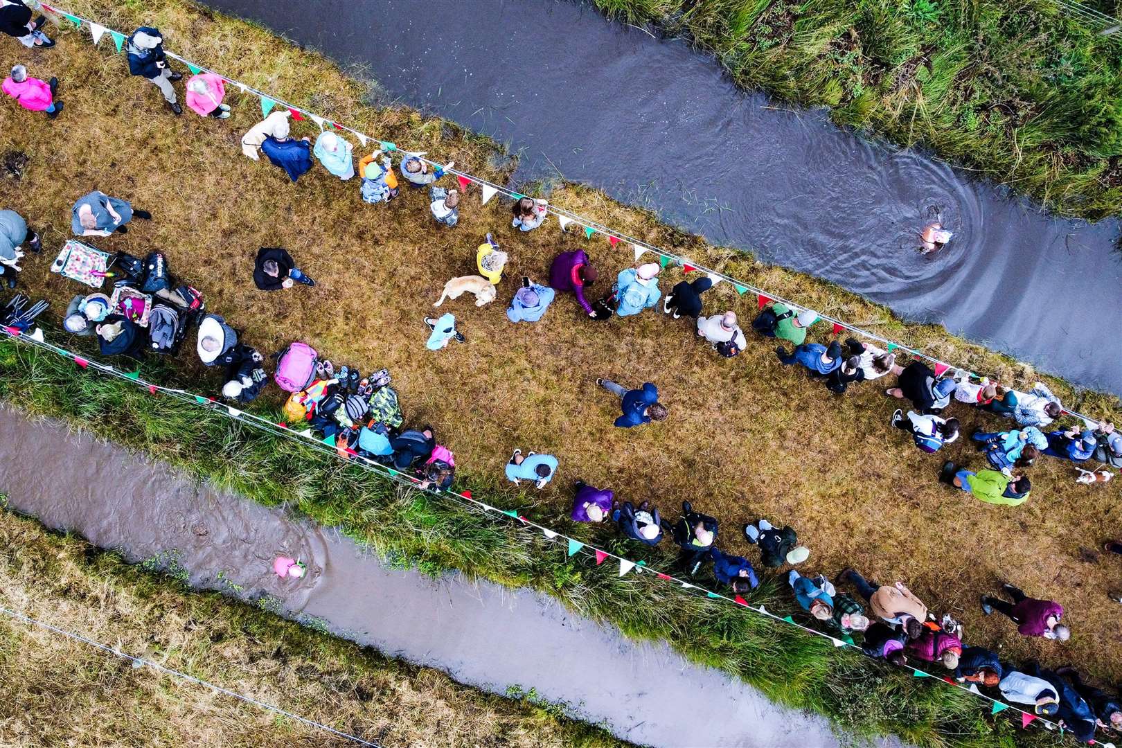 Spectators lined the banks of the bog (Ben Birchall/PA)