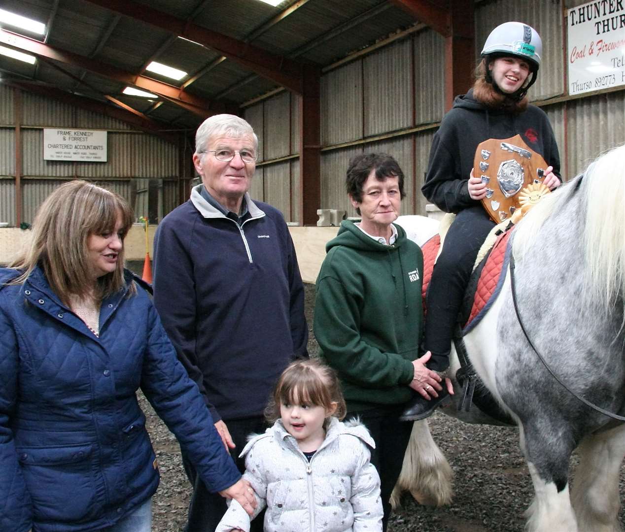 Robbie Keith and Heather and Paige handing to Natasha Gunn along with RDA volunteer Evelyn Dunnet.