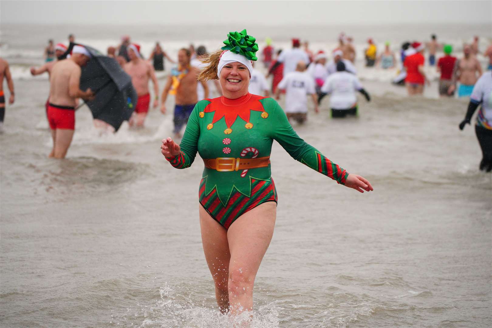 In Porthcawl, Wales, swimmers donned festive suits and even remembered the bow (Ben Birchall/PA)