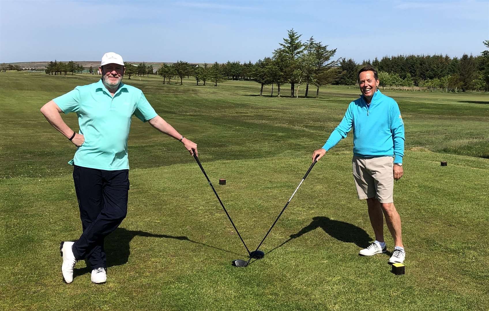 Thurso Golf Club's captain Alan Coghill (right) and vice-captain James Taylor on the first tee and observing social distancing.