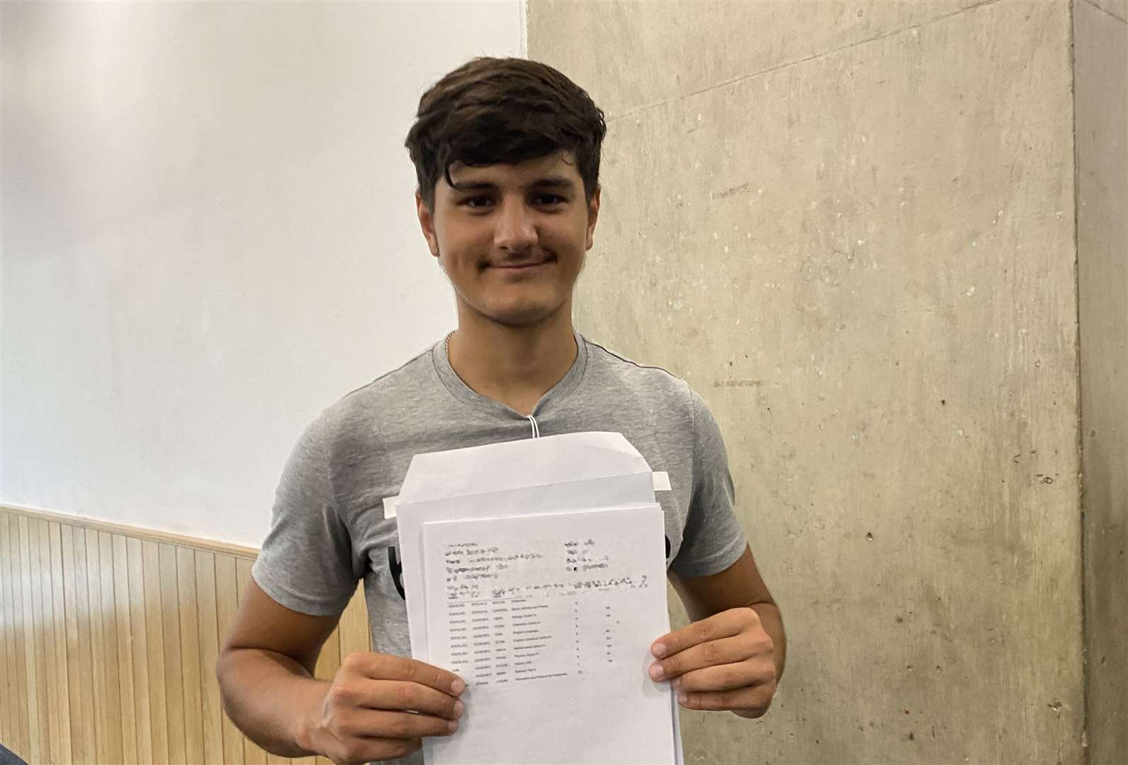 Adam Qureshi receiving his GCSE results at Westminster Academy (Claudia Rowan/PA)