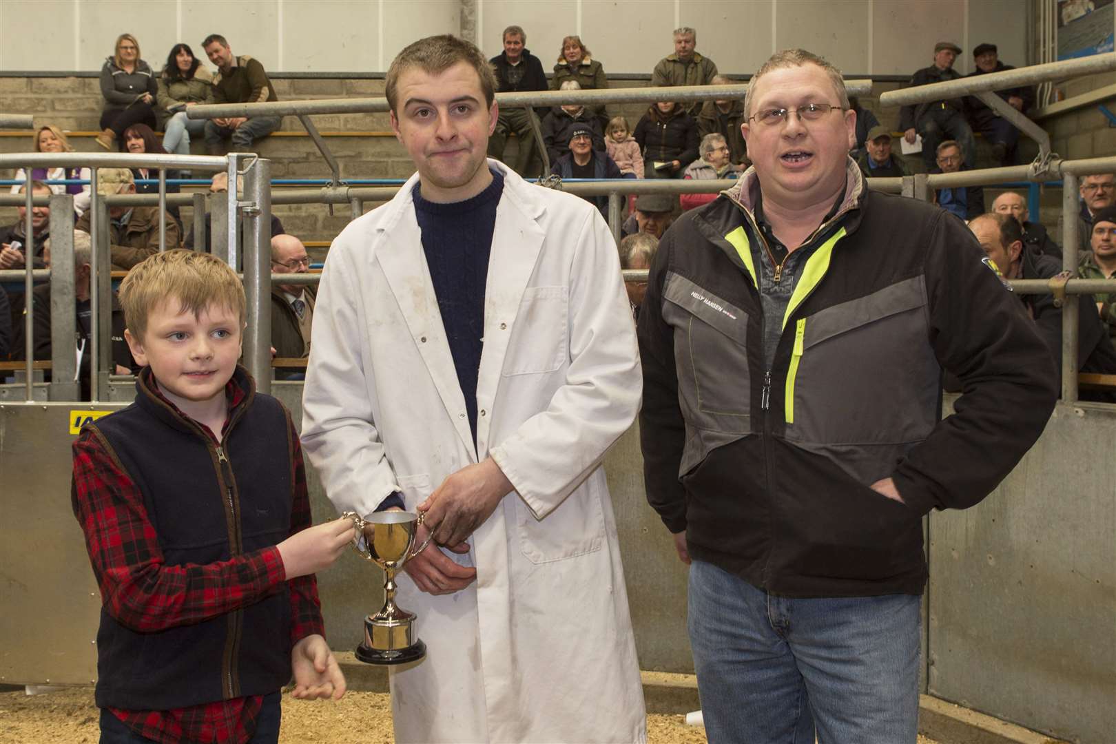 Bower Young Farmers Club member James Gunn, Whitefield, Wick, took the young farmers' overwintering cattle championship at Aberdeen and Northern Marts, Caithness Livestock Centre's show and sale. His champion, a 12-month-old cross Limousin stot, scaled 555kg and sold at £1320 to show judge Blair Duffton, of Backmuir Livestock, Keith. The trophy was presented on behalf of sponsor Mackay, West Greenland, by seven-year old Dhail Mackay, whose uncle, Andrew, is looking on.