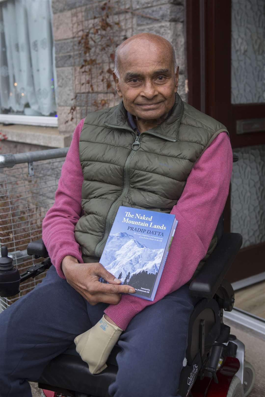 Pradip Datta, MBE MS FRCS (1940-2022), with his earlier book, The Naked Mountain Lands. Picture: Robert MacDonald / Northern Studios