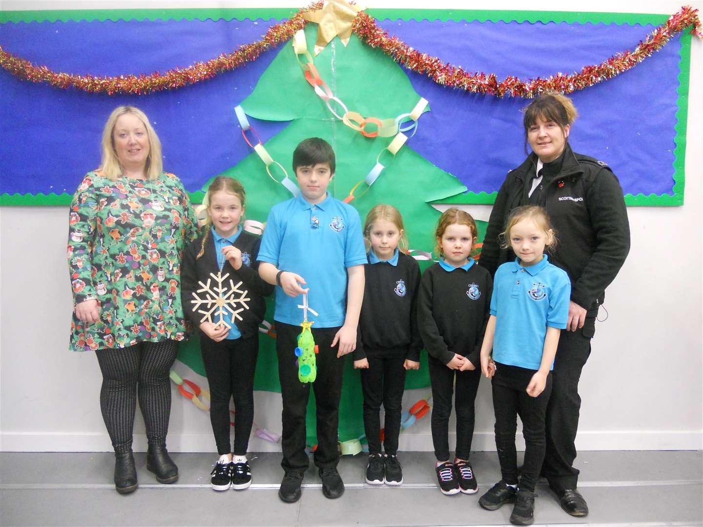 Dee Roberts, the teacher in charge of the eco committee, along with (from left) pupil members Zara MacKintosh (P5), Donald Farquhar (P7), Merryn Murray (P4), Megan Murray (P3) and Scarlett Heddle (P2), with Christine Lord from the SSPCA. Also a committee member but not in the photo is Samuel MacKintosh (P1).