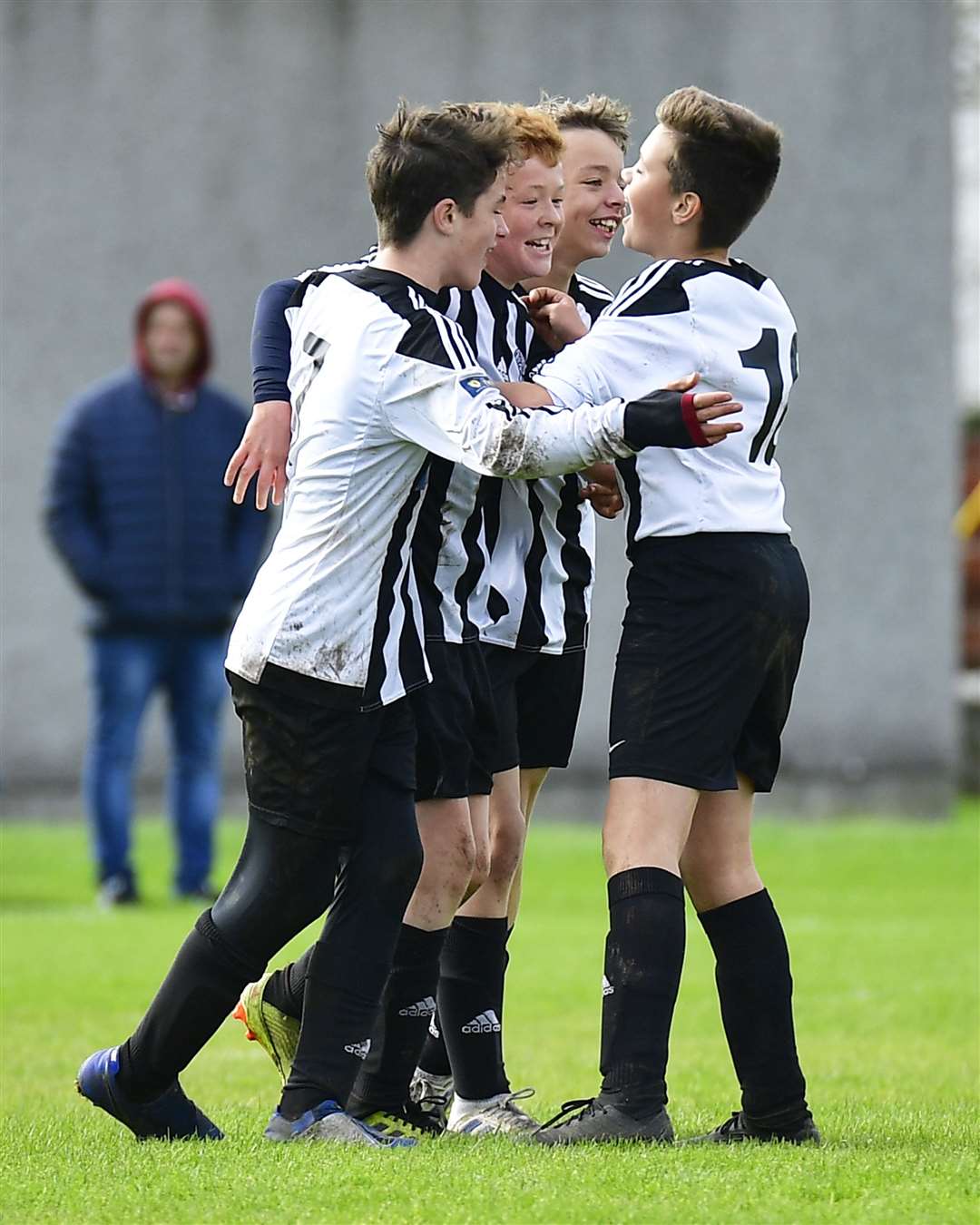 Euan Kennedy, Lee Gordon and Owen Bain celebrate with Morgan Kennedy after he scored the decisive fourth goal for United. Picture: Mel Roger