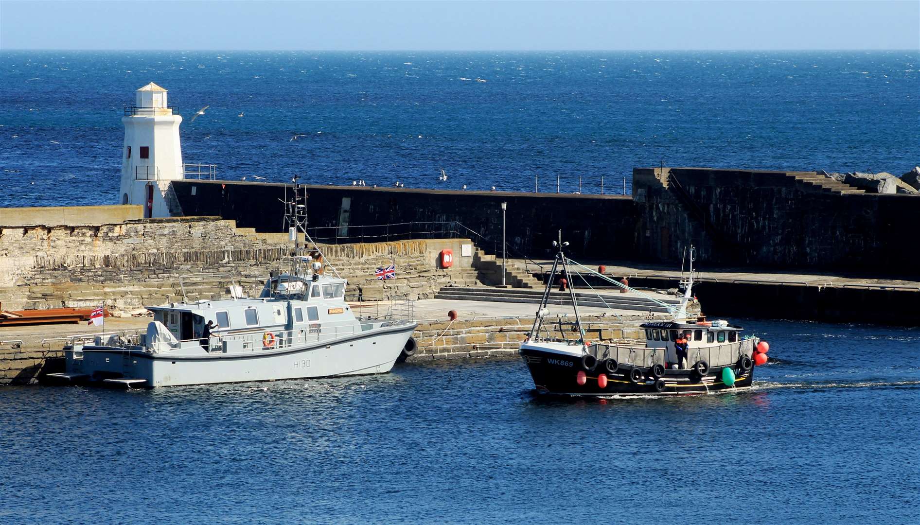 HMS Magpie in Wick harbour on Friday as a fishing boat passes by. Picture: Alan Hendry