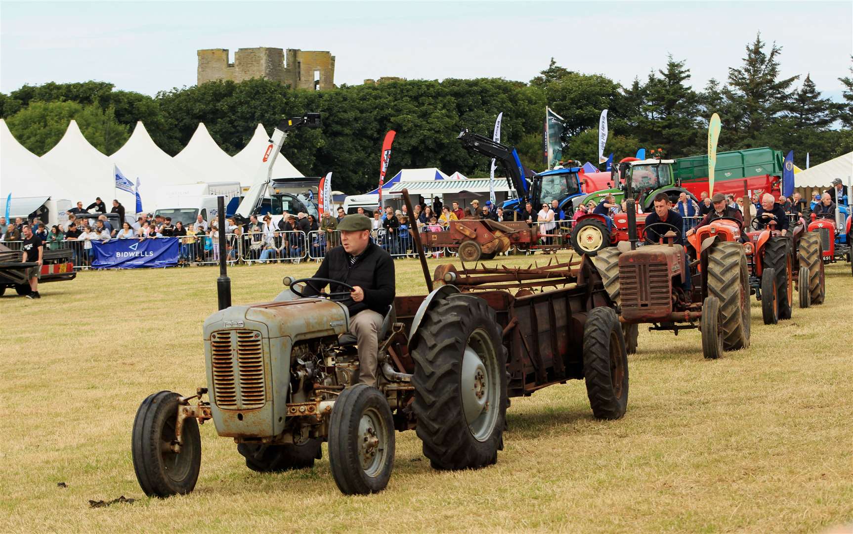 The vintage tractor parade around the main ring at Thurso East. Picture: Alan Hendry