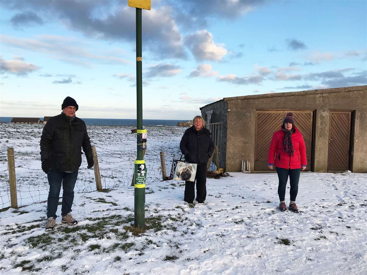 Pat Ramsay (right) with her husband Grant and local resident Pam Jack after they installed one of the poo-bag dispensers. All three are members of Staxigoe, Papigoe and Noss Resilience Group.