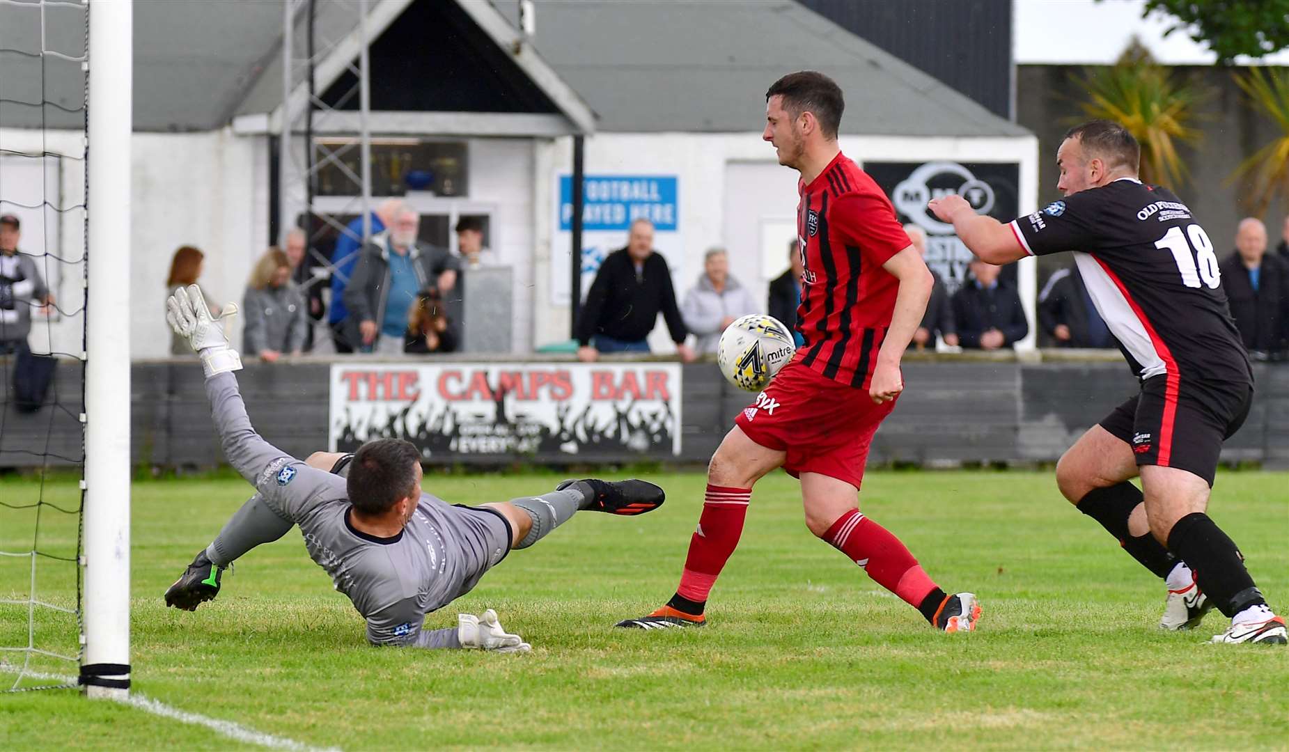 Wick Academy keeper Graeme Williamson pulls off a point-blank save to deny Fraserburgh's Sean Butcher. Picture: Mel Roger