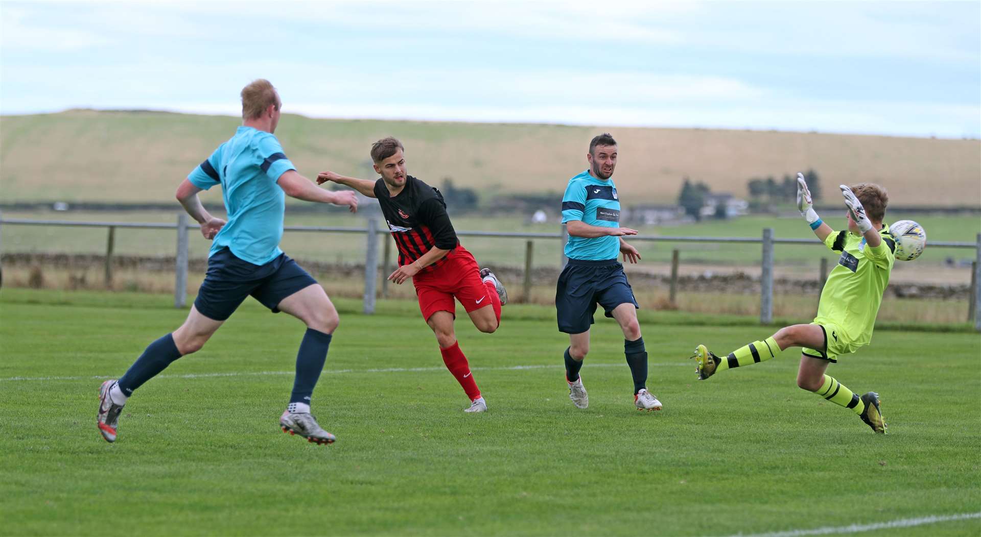 Halkirk United striker Jonah Martens fires the ball past Lewis Bannerman for the opening goal. Picture: James Gunn