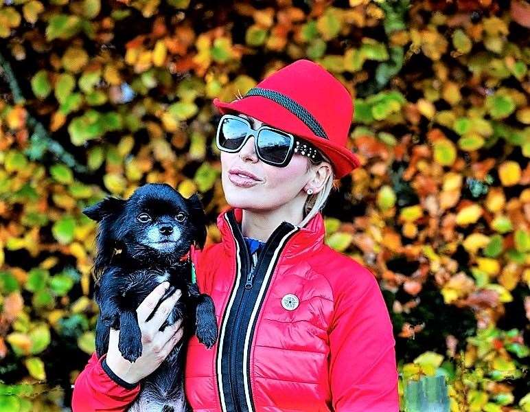 Natalie wears her purple poppy badge and holds Louis the chihuahua. Picture: Ray Hilton
