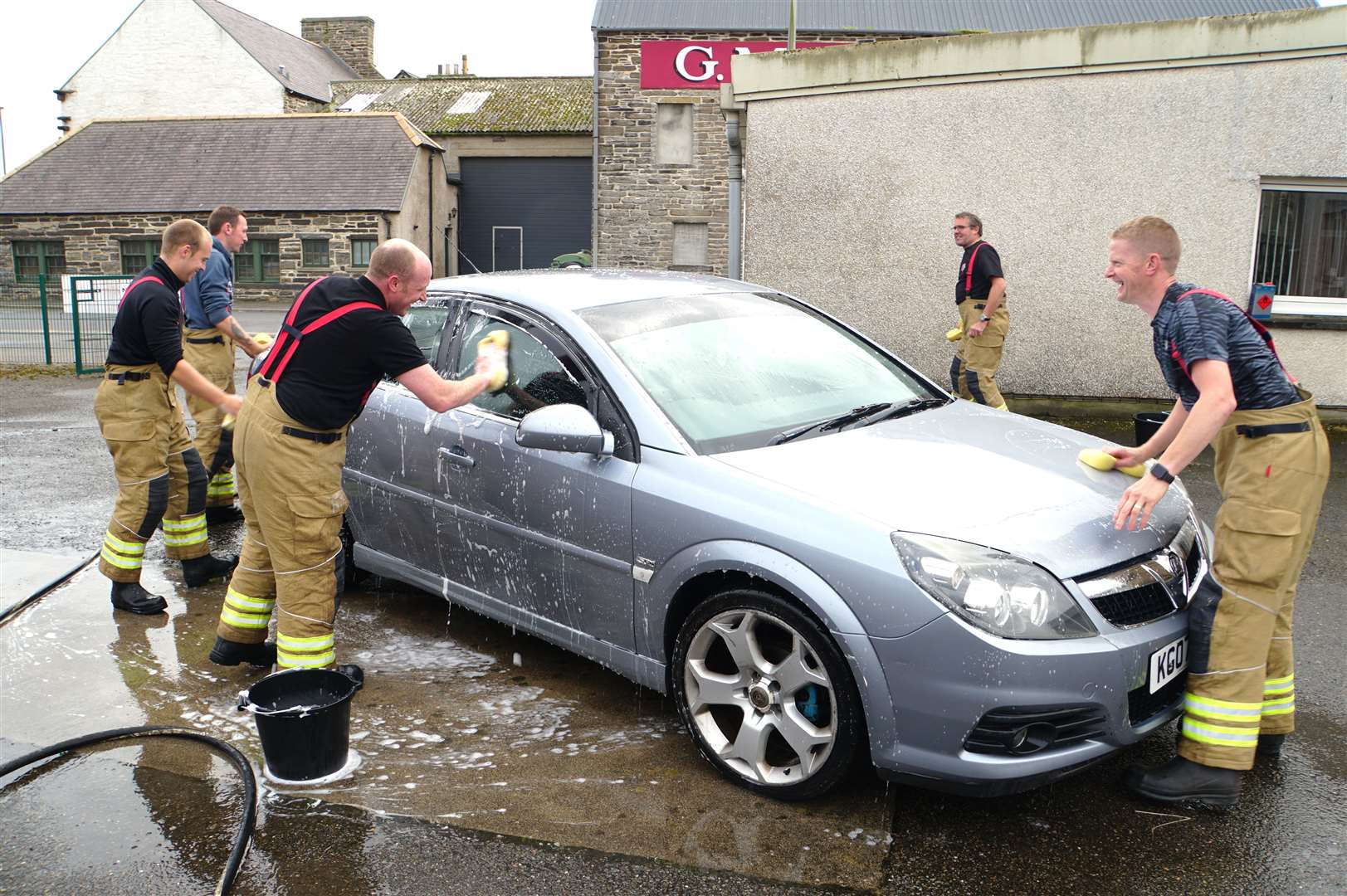 The Wick fire fighters get stuck in at National Car Wash Day. Pictures: DGS