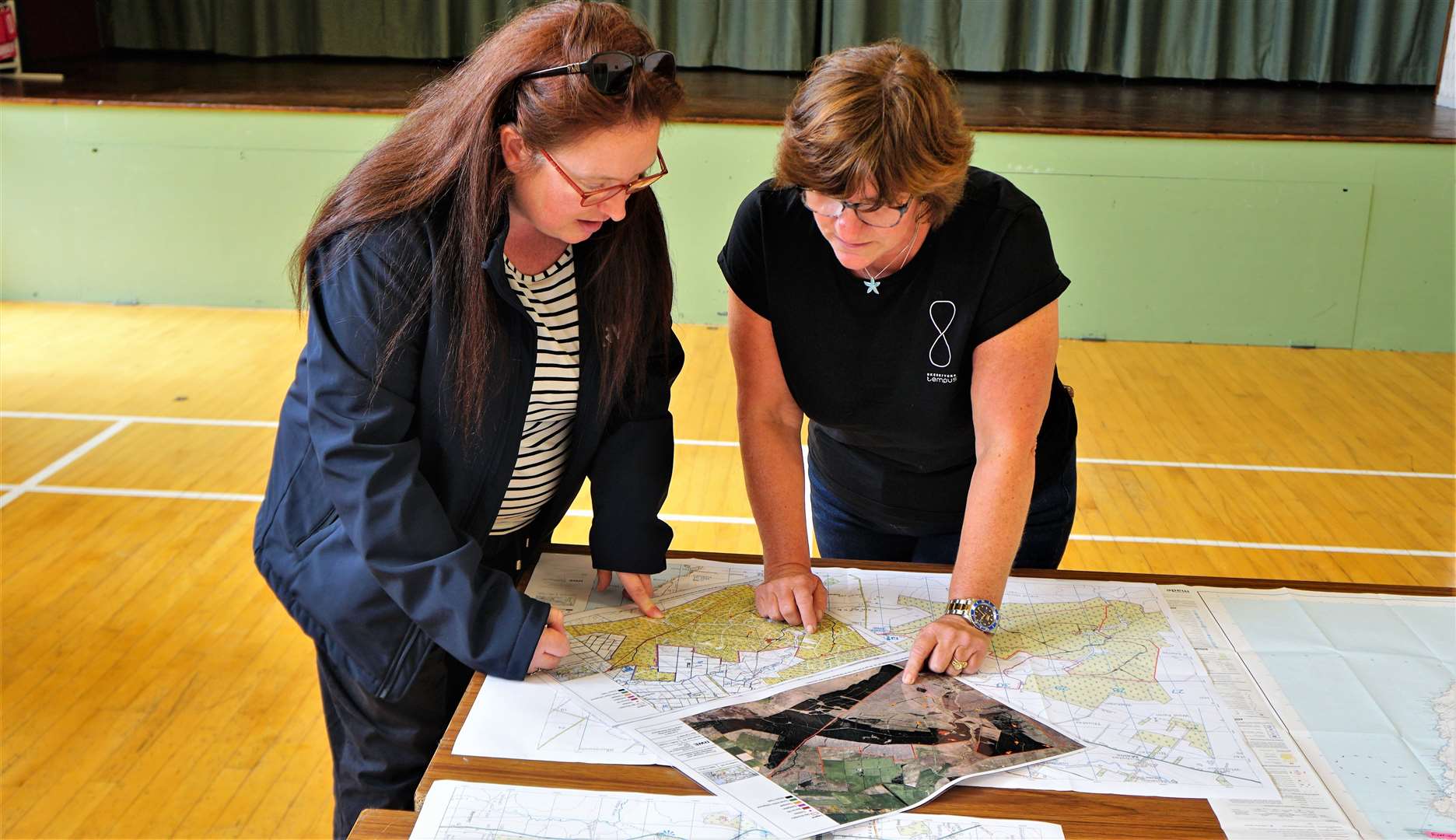 Archaeology student Susan Taylor is shown plans for the wind farm. Picture: DGS