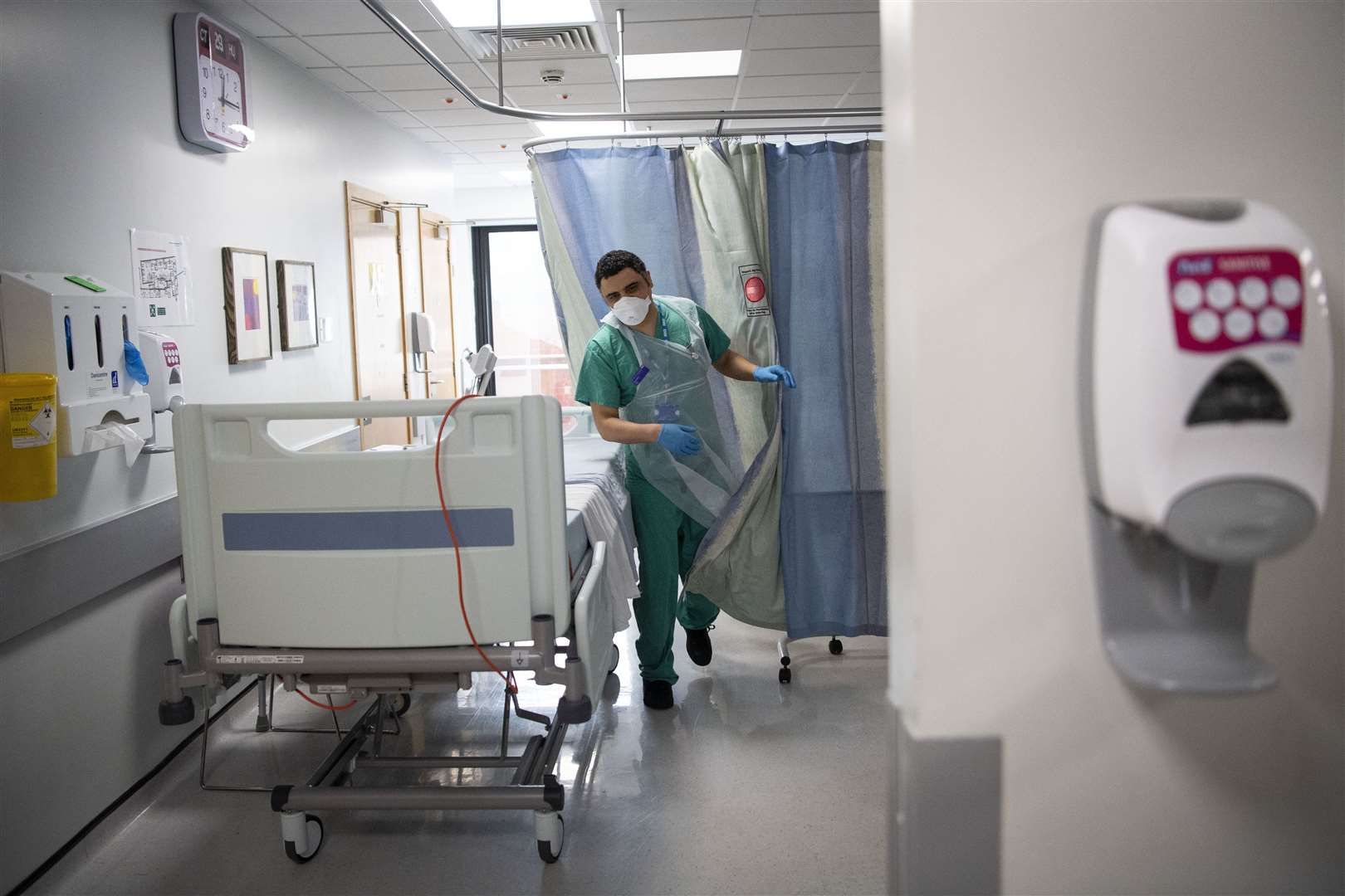 A staff nurse walks through the Acute Dependency Unit after taking food to a patient (Victoria Jones/PA)