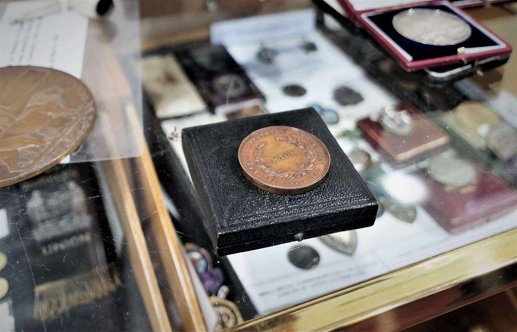 The bronze medal is dated 1868 and was made for the Caithness Industrial Exhibition of that year. It sits on the display case where it will be on show along with other historic medals.