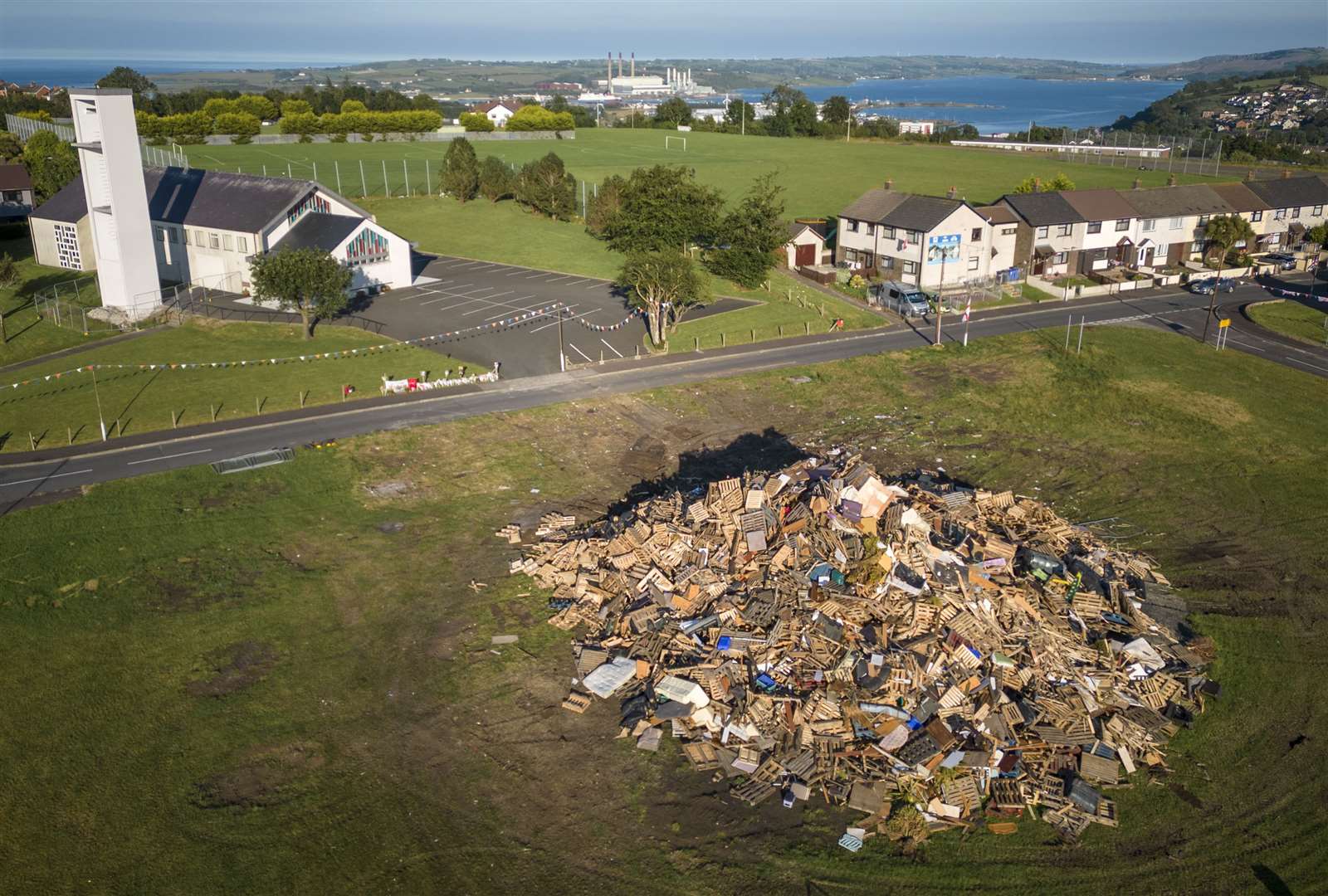 The dismantled bonfire after a man died after falling from it on the Antiville estate in Larne, Co Antrim (PA)