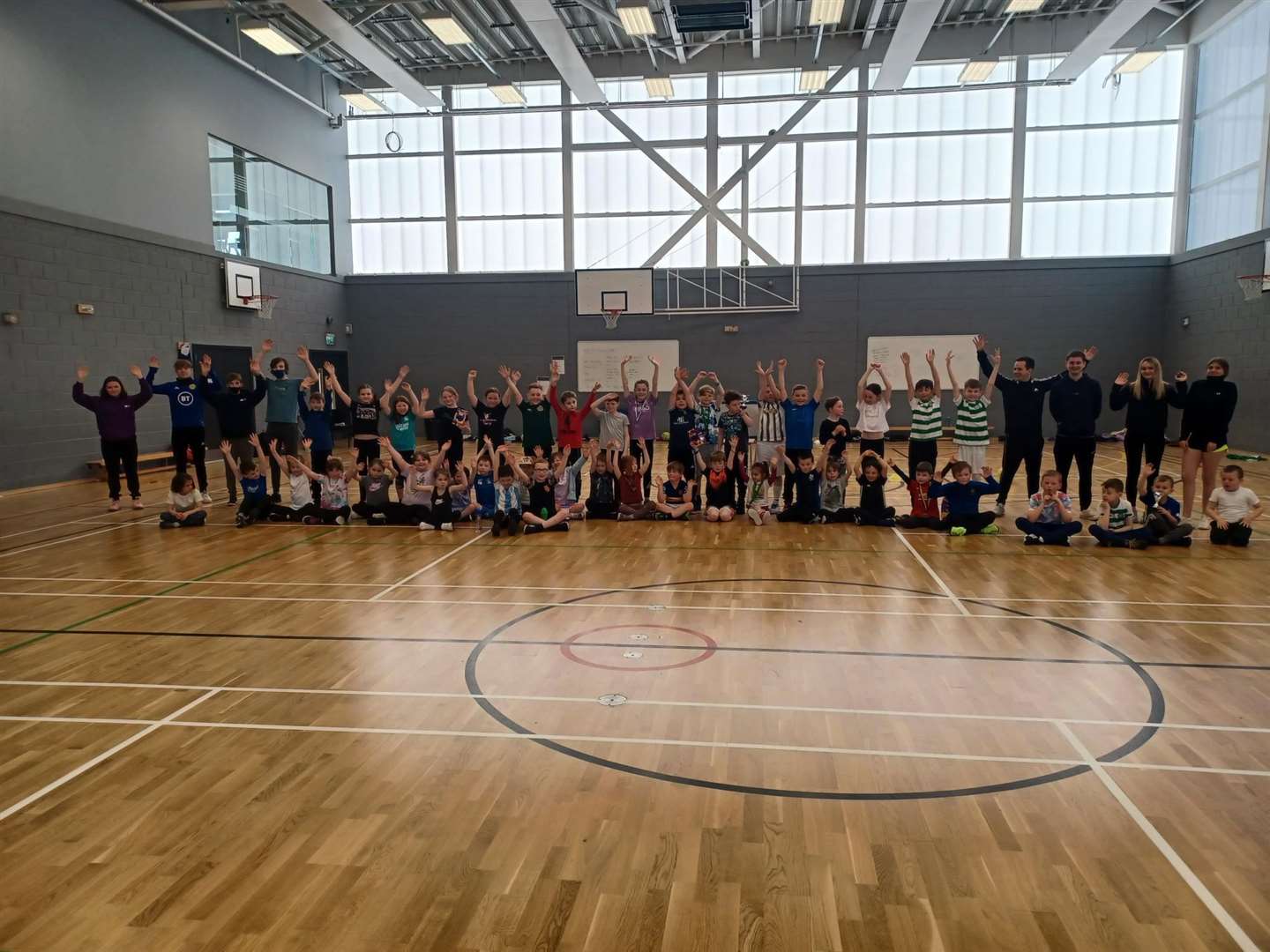 Hands in the air as children and coaches line up at the Wick Active Schools Easter camp.