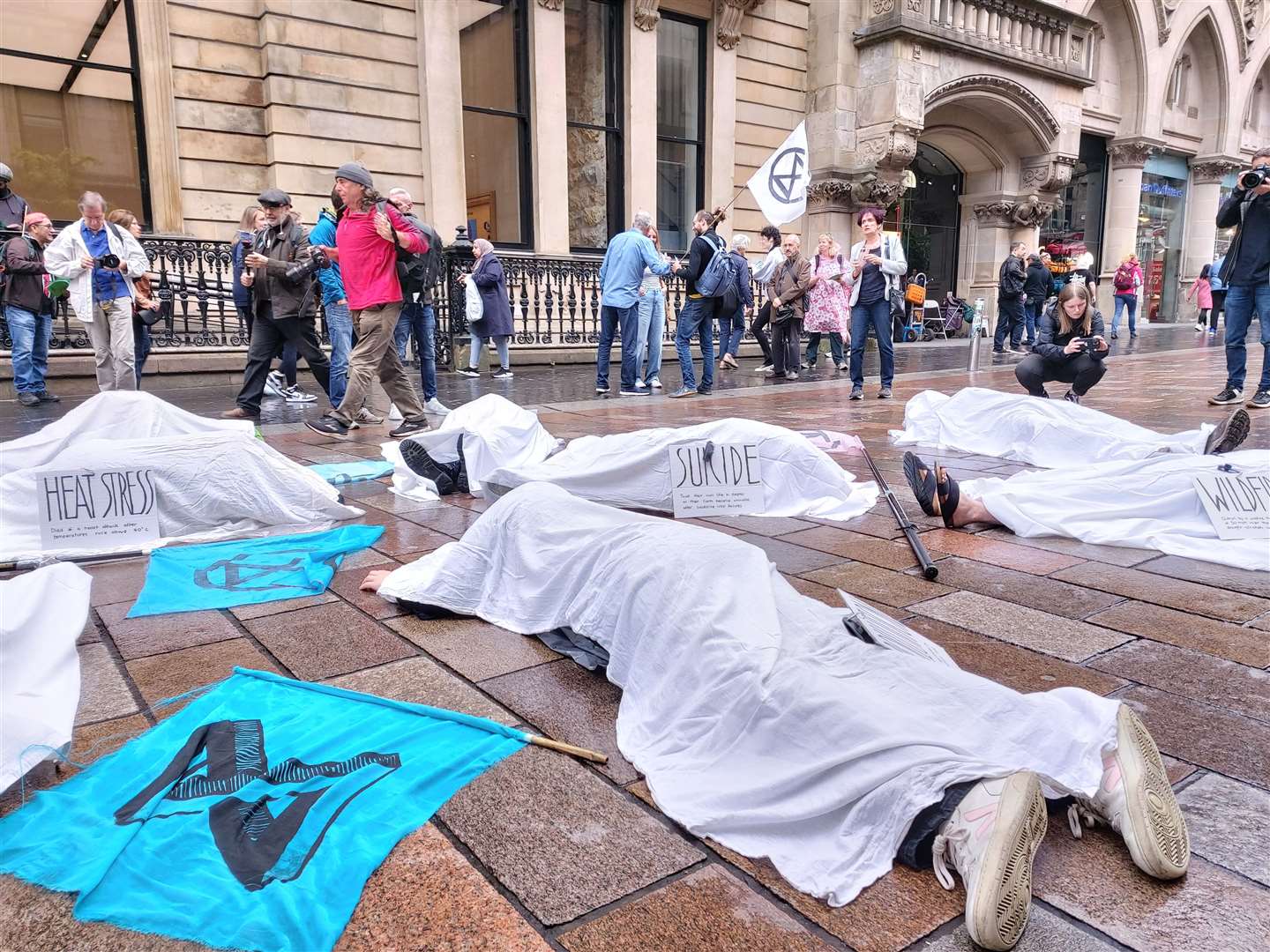 Extinction Rebellion protesters staged a ‘die in’ on Glasgow’s Buchanan Street following the heatwave (Extinction Rebellion Scotland/PA)