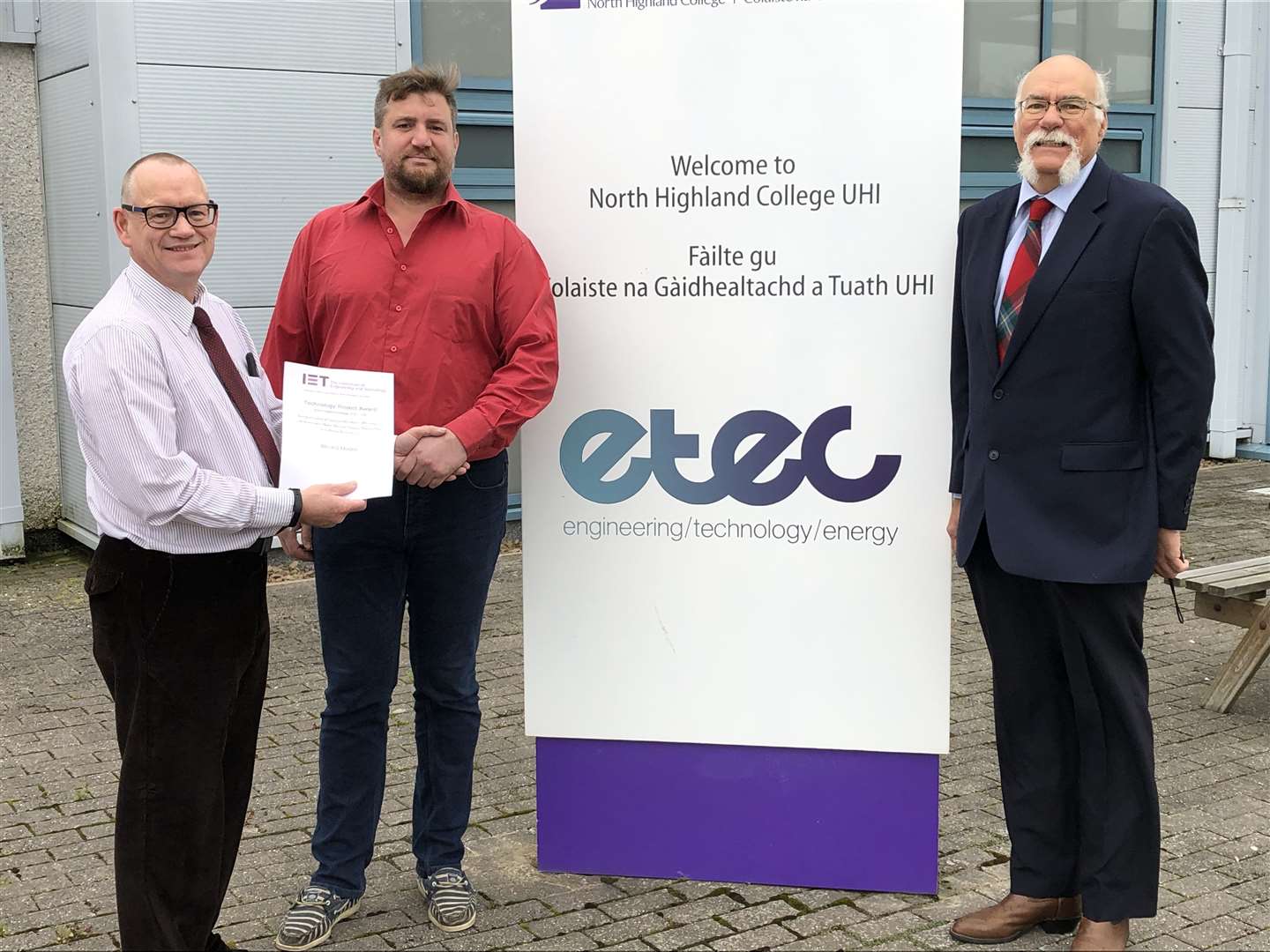 John Blacklock, Thurso chair of IET, congratulates award winner Gilles Favier. Looking on is Peter Hylton, programme leader at North Highland College UHI.