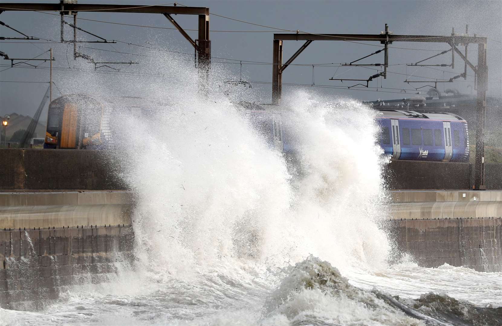 Alas, it was never going to last forever. A train passes in Saltcoats on the west coast of North Ayrshire as Storm Ellen approached later in the month (Andrew Milligan/PA)