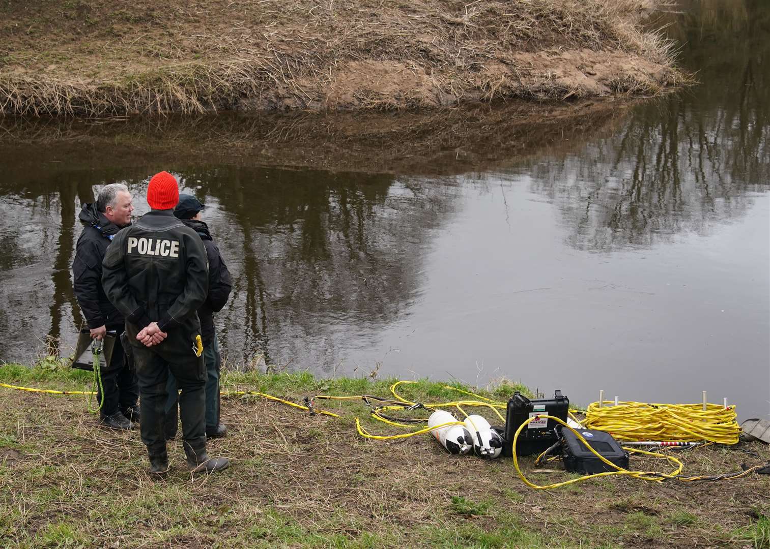 Police search teams on the banks of the River Wyre (Peter Byrne/PA)