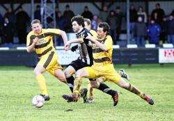 Sean Mackay, man of the match, bursts past Graham Grant (right) and Nathan Sharp to advance on goal.